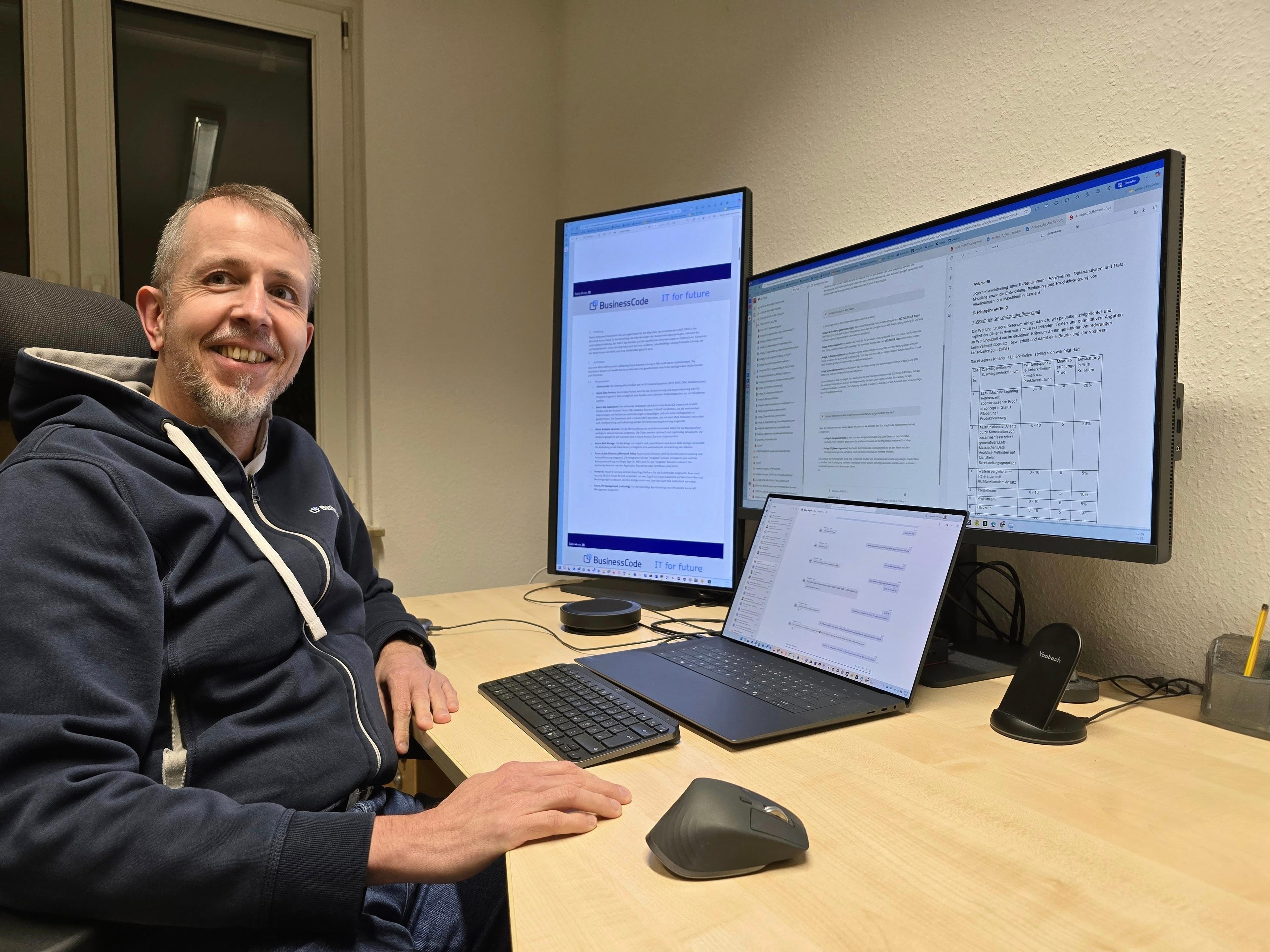 Harald Wagener at his workspace with multiple monitors showing tender documents