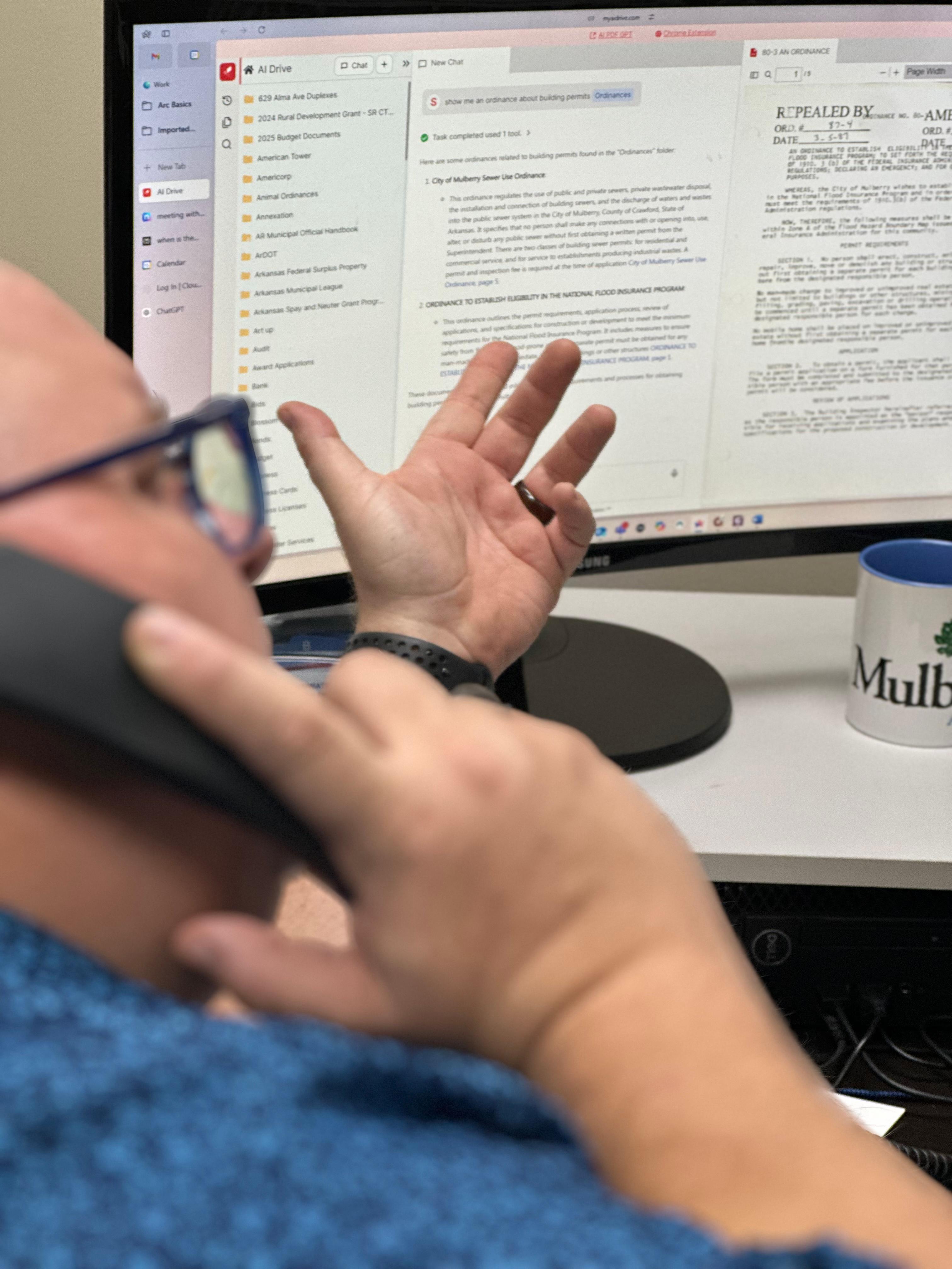 AI Drive interface showing document management system with folder structure, searchable content, and scanned documents, alongside a Mulberry branded mug